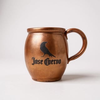 Copper Jose Cuervo mug with raven logo and curved handle on white background